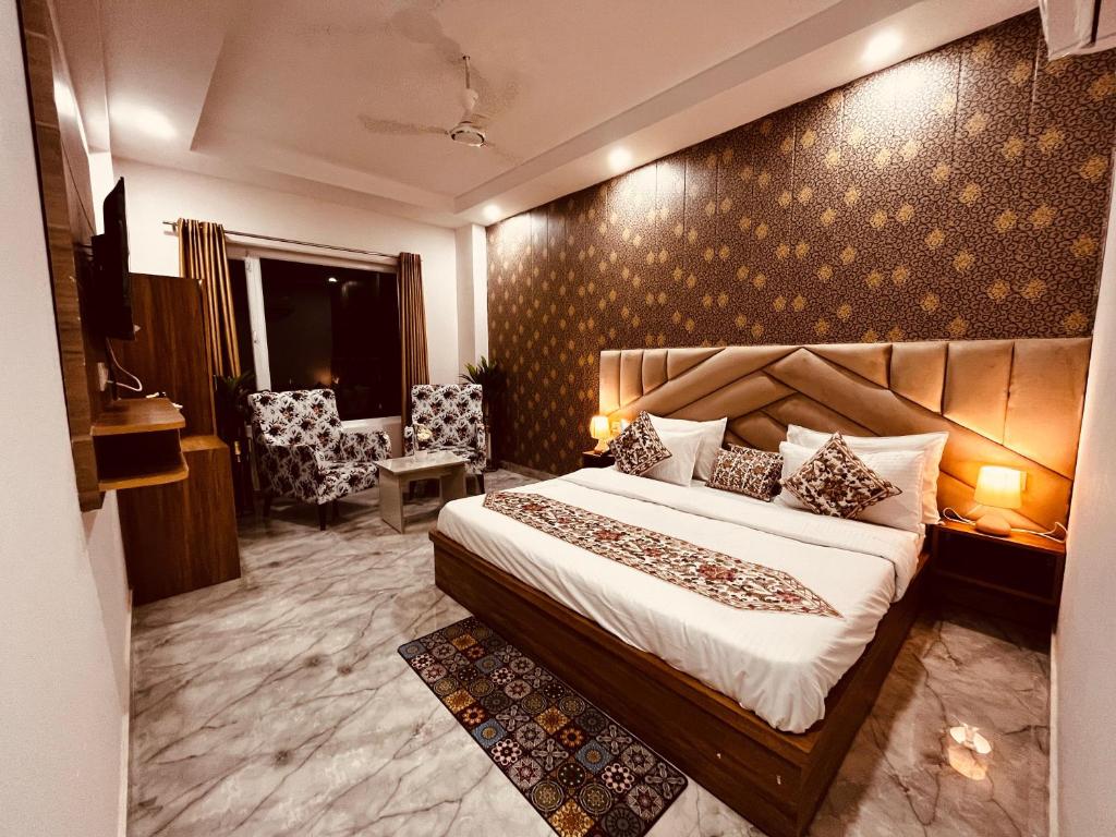 a hotel room with a bed and a chair at Hotel The Meridian, Near Har Ke Pauri Road - Haridwar in Haridwār