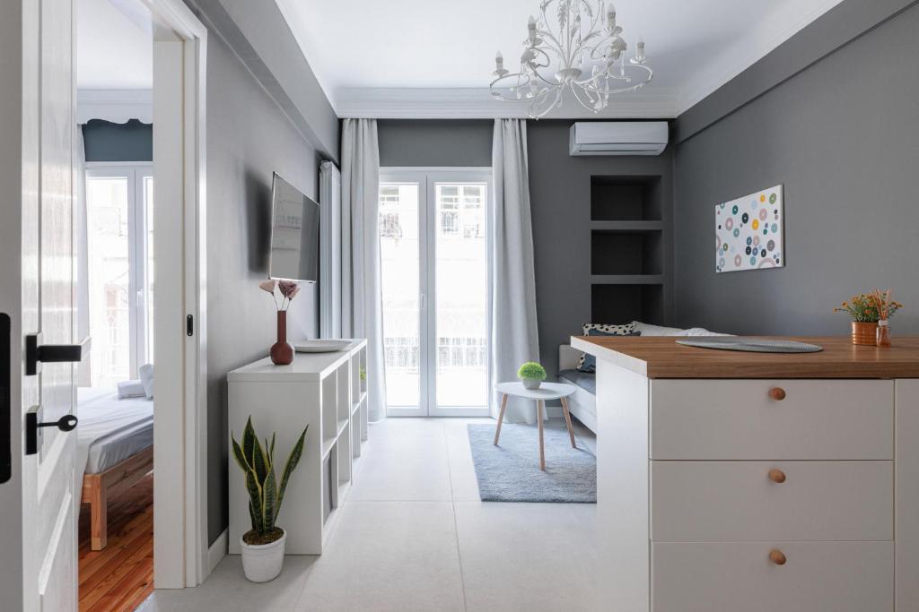 a kitchen with a white cabinet and a table at Lumahaus Chamber Palaiologou in Thessaloniki