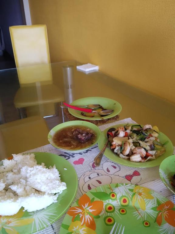 a table with plates of food on a table at Room in apartment, bolme in Almaty