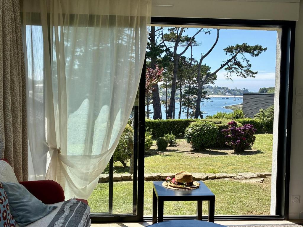 a living room with a large sliding glass door at Vue mer - Maison pour 8 - Grand jardin in Lannilis