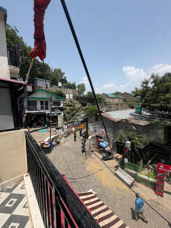 a group of people walking down a street at Rudra Home stay l On heritage Market kasauli l Best food Cafe Rudra l Kasauli in Kasauli