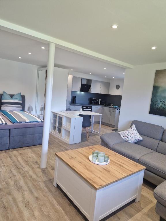 a living room with a couch and a table at Ferienwohnung Landglück in Haale