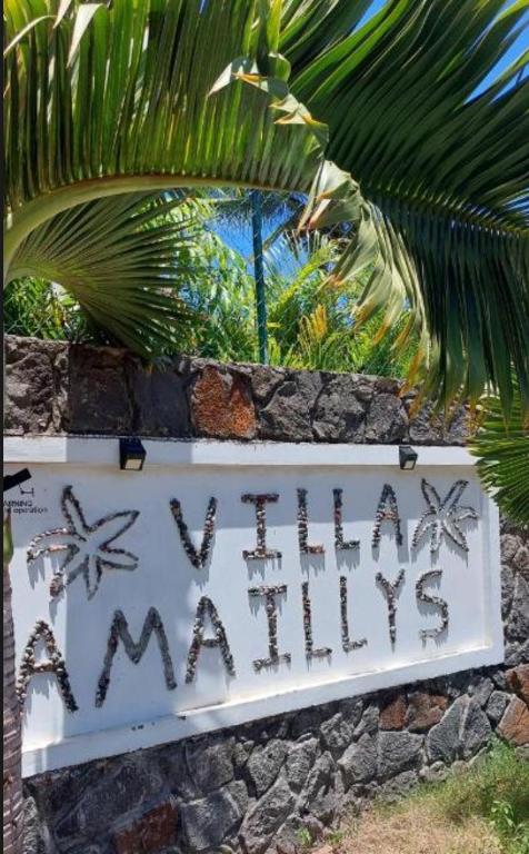 a sign that says unhappy unhappy on a stone wall at Sea La Vie Villa in Grande Gaube