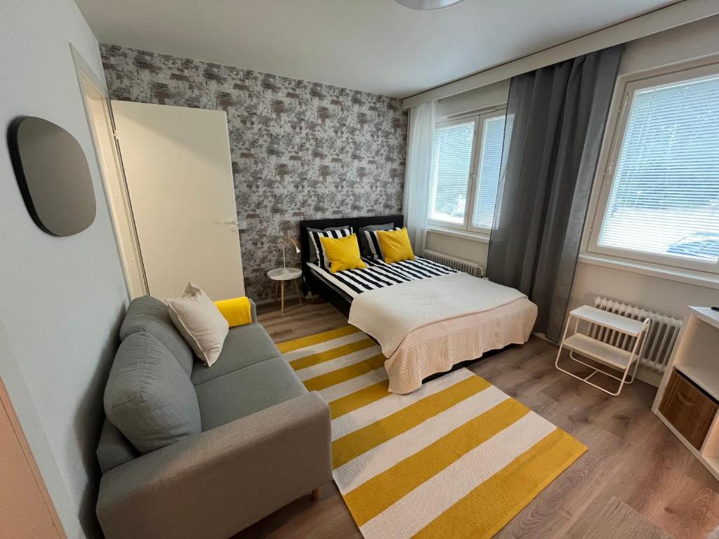 a living room with a couch and a bed at Kotkanlankila in Kotka