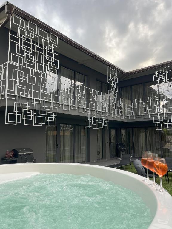 a building with a large pool in front of it at Villa Alveare in Banya