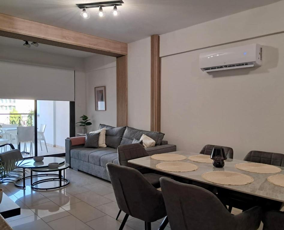 a living room with a couch and a table and chairs at Lama's Residence in Nicosia