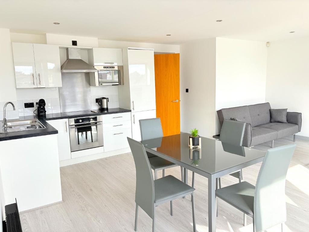 a kitchen and dining room with a table and chairs at Modern 2-Bed Apartment in York City Centre - Walk to Shambles and Top Attractions in York