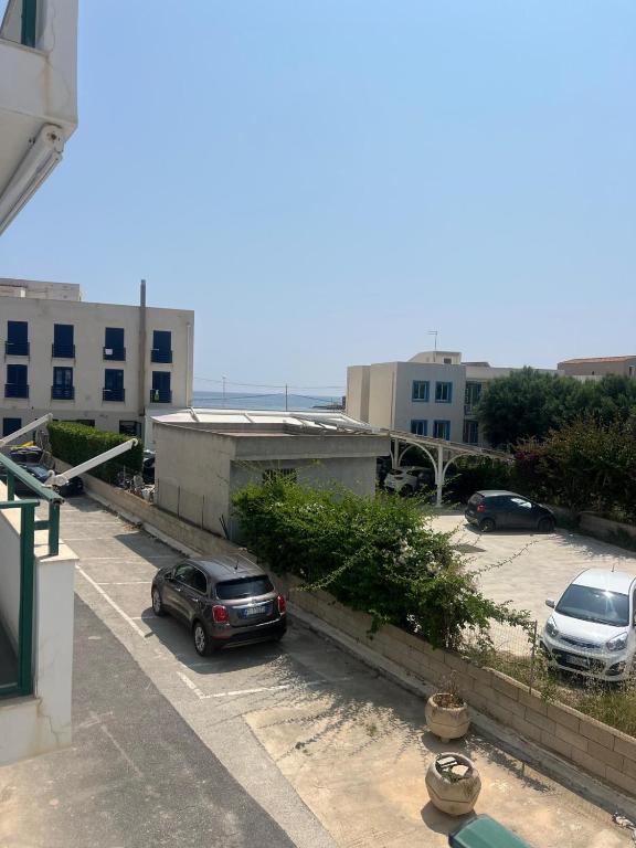a parking lot with two cars parked in it at Casa Artemisia in Marzamemi