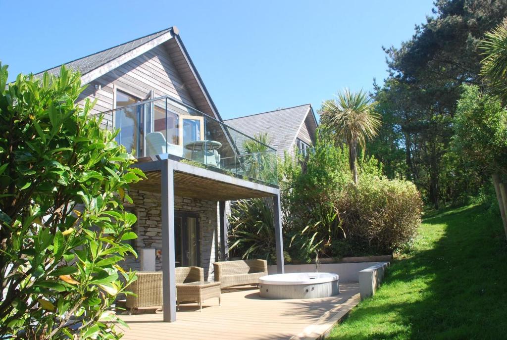 a house with a deck with a tub in the yard at House 28 in Looe