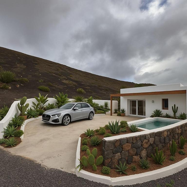 a car parked in front of a house at Luxury House La Maison in Tías