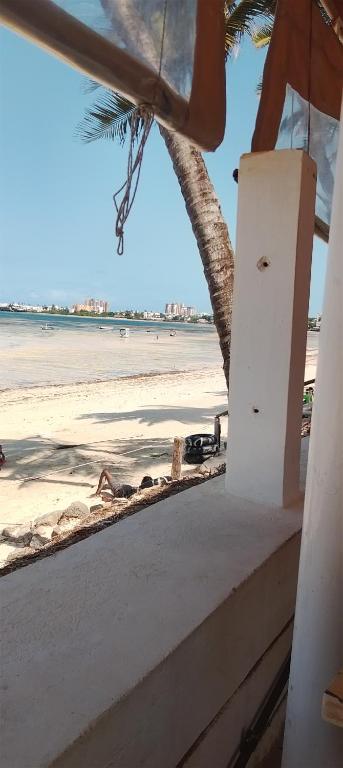 a view of the beach from the balcony of a beach house at Serene Luxury Seaview Homestay Nyali Msa in Mombasa