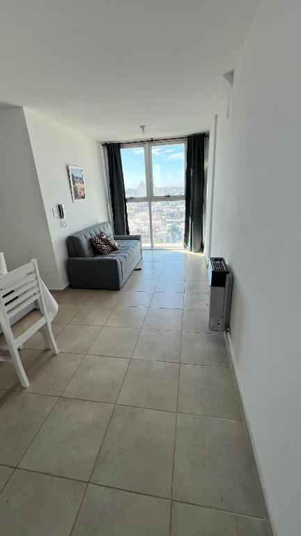a living room with a couch and a large tile floor at Cata in Villa María