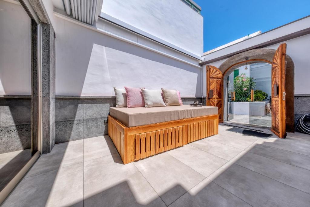 a bed in a room with a window at Casita Moritz - Luxury - 1 min to the Beach By Lanzarote Vacation Homes in Costa Teguise