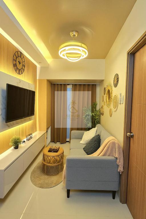 a living room with a couch and a tv at Seyuri Staycation Haven in Manila