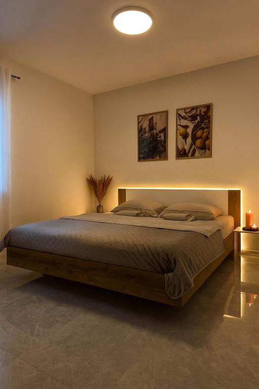 a bedroom with a large bed in a room at Olea apartments in Pobegi