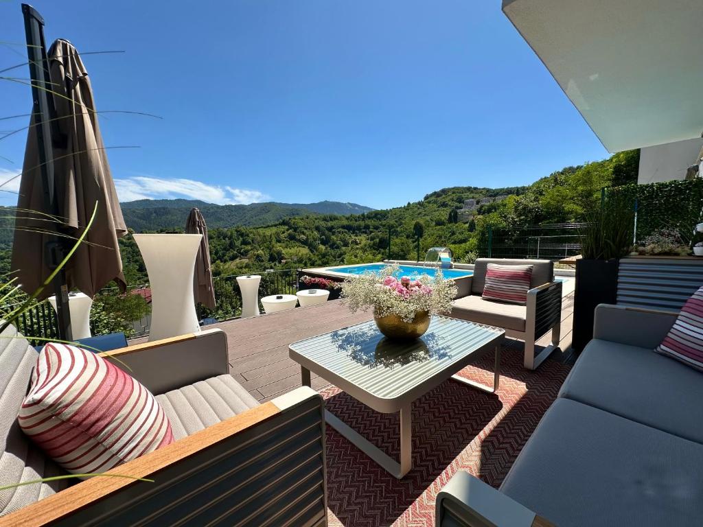 a patio with a table and chairs and a pool at Imperia Luxury Vila in Braşov