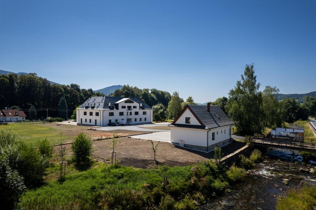 an aerial view of two white buildings with trees at Ulrichova vila a Vilka Rejhotice in Šumperk