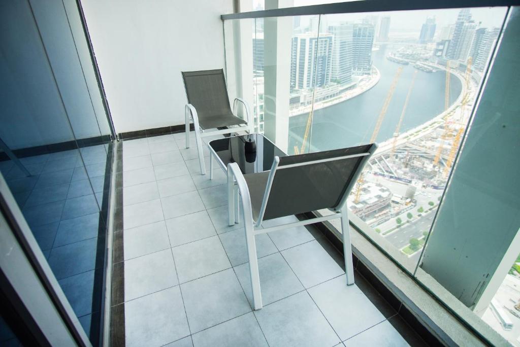 a chair in a building with a view of a city at Luxury Studio Bayz By Danube Business Bay Marasi Drive Dubai in Dubai
