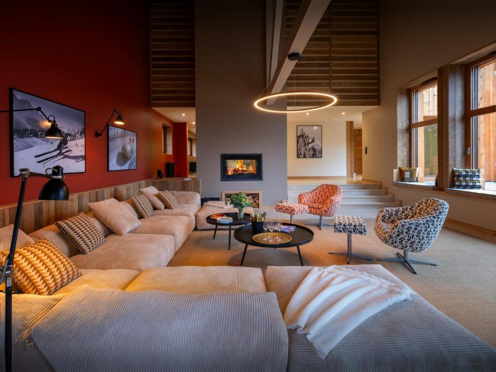 a large living room with couches and chairs at Chalet La Parenthèse - OVO Network in Samoëns
