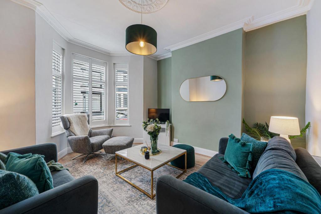 a living room with a couch and a table at Watford Lodge - Air Host & Stay - A Home in the Heart of Anfield in Liverpool