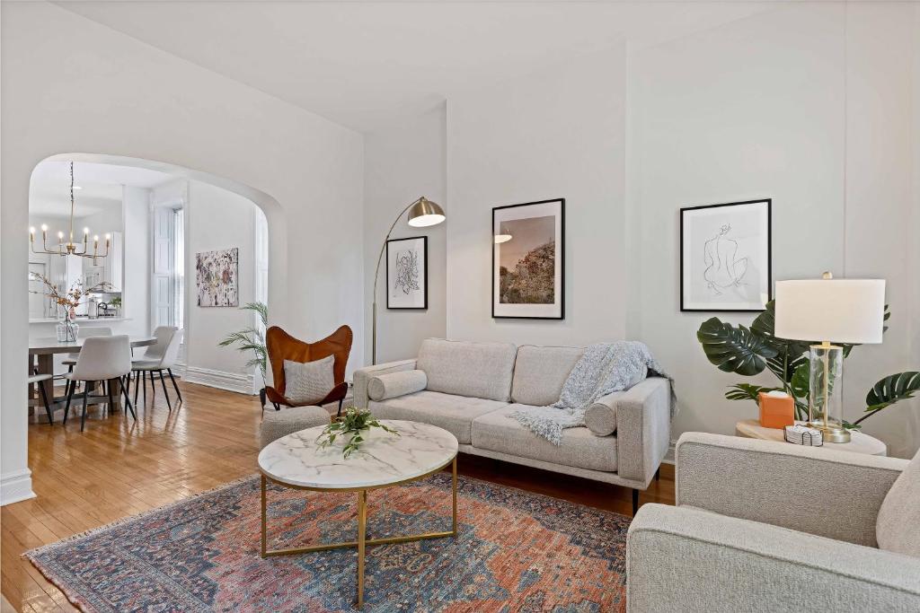 a living room with a couch and a table at Newly Updated Vintage 6 Bedroom Single Family Home home in Chicago