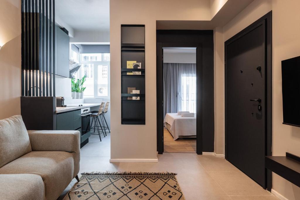 a living room with a couch and a table and a kitchen at TWO ENTIRE APARTMENTS LIV Luxury Central C-D in Thessaloniki