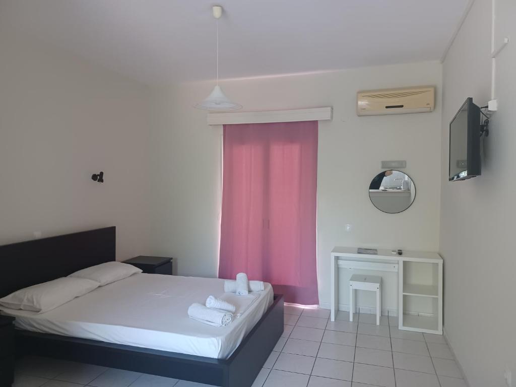 Postel nebo postele na pokoji v ubytování Tassos & Marios Apartments I