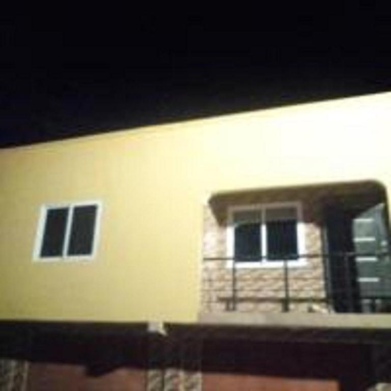 a building with two windows and a balcony at Executive Apartment in Cape Coast