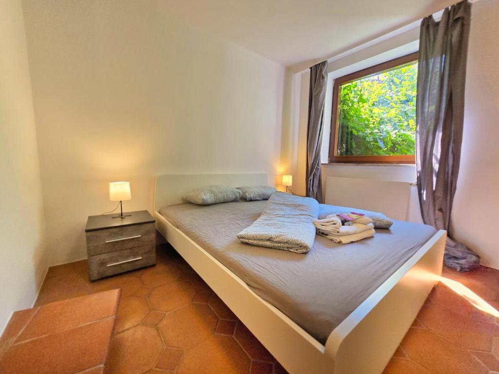 a small bedroom with a bed with a window at Innsbruck Nature & City House I Free Parking in Innsbruck