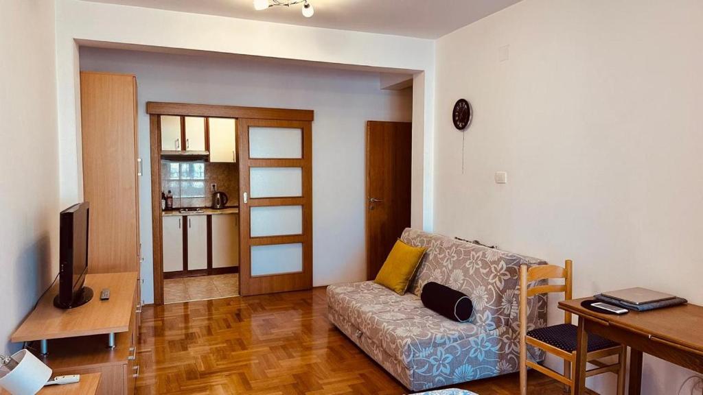 a living room with a couch and a table at Budva Summer House in Budva