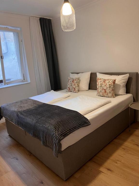 a large bed in a room with a window at Cocoon City in Stuttgart