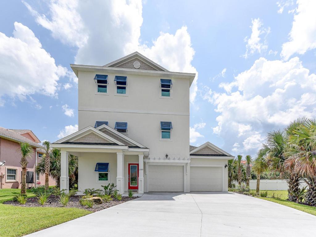 a white house with a garage at Atlantic Beach House in Flagler Beach