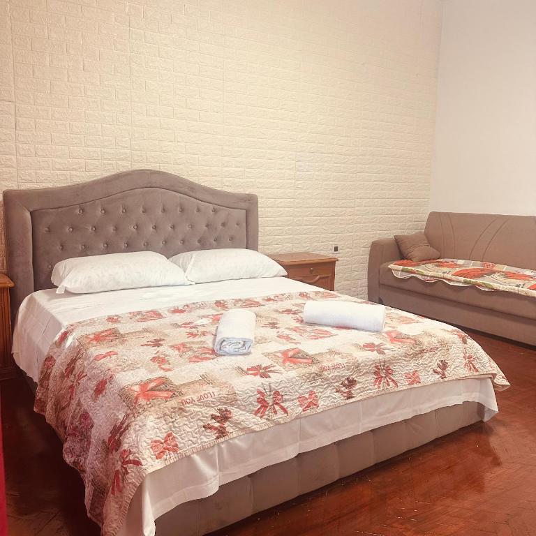 a bedroom with a bed with two towels on it at Venice Cappucina Guest House in Mestre