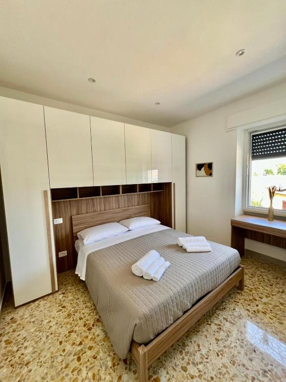 a bedroom with a bed with two towels on it at B&BPodere1149 in Villafranca