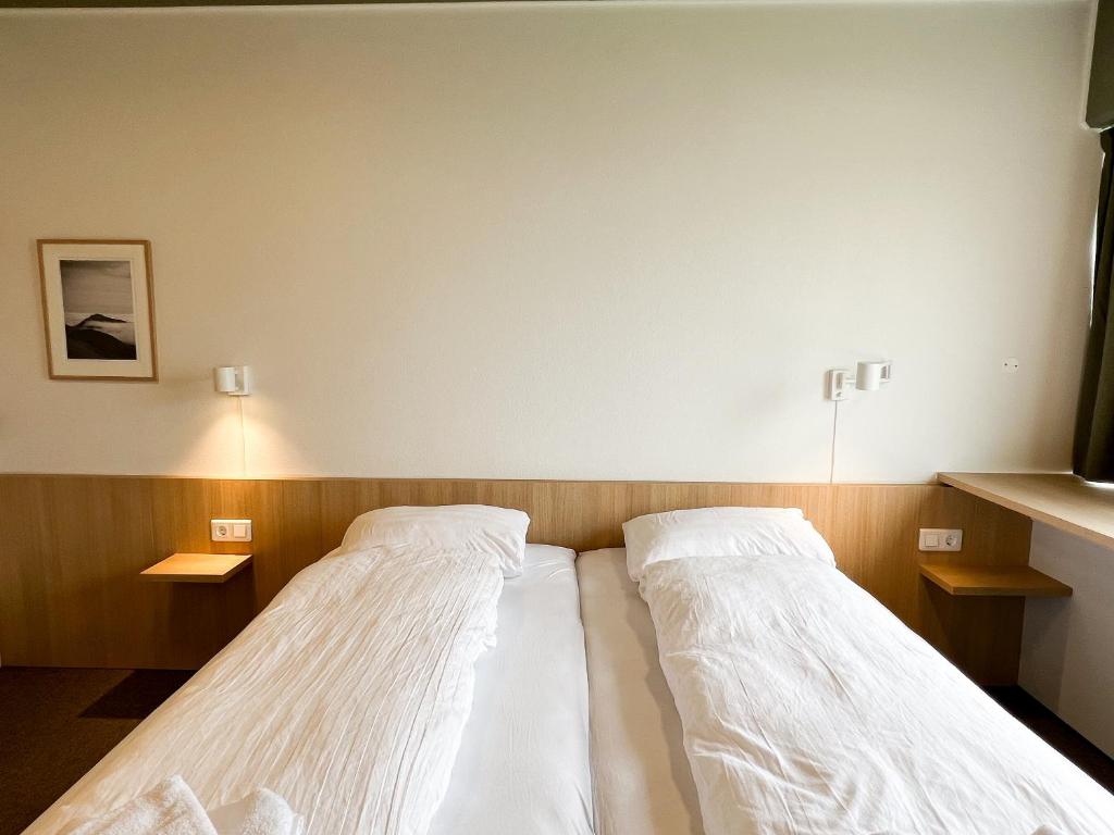 Voodi või voodid majutusasutuse Eiðar - Hostel toas