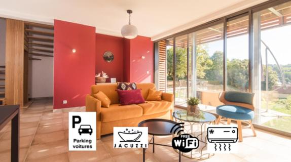 a living room with a couch and a table at 100% Relax avec Jacuzzi Privatif in Sarlat-la-Canéda