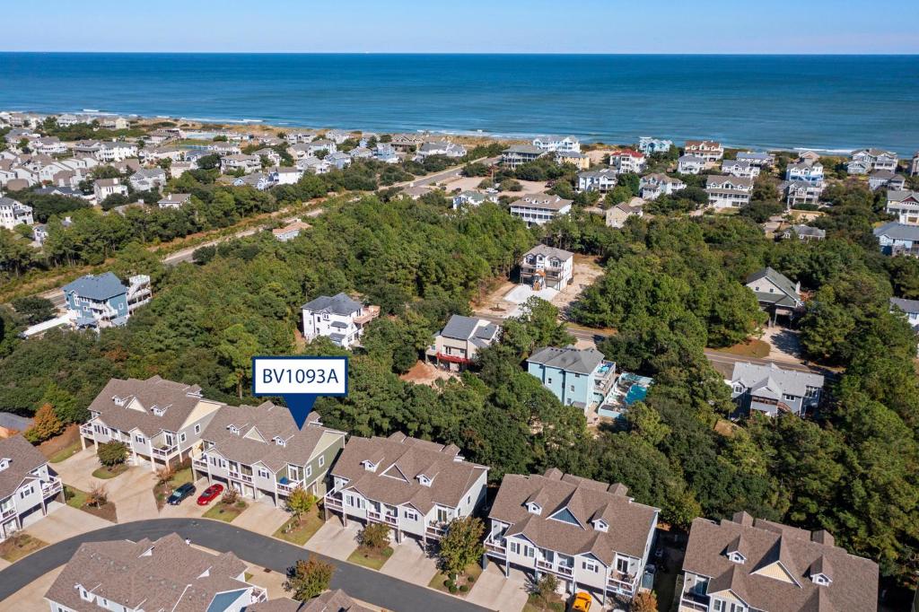 an aerial view of a neighborhood with houses and the ocean at Beachaholic in Corolla
