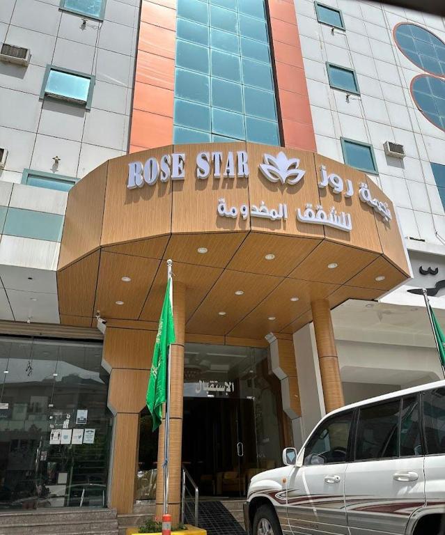 a car parked in front of a building at Najma Roz Hotel in Abha