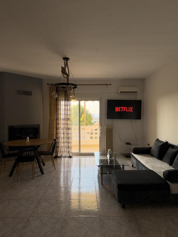a living room with a couch and a table at Erra Stay in Perea