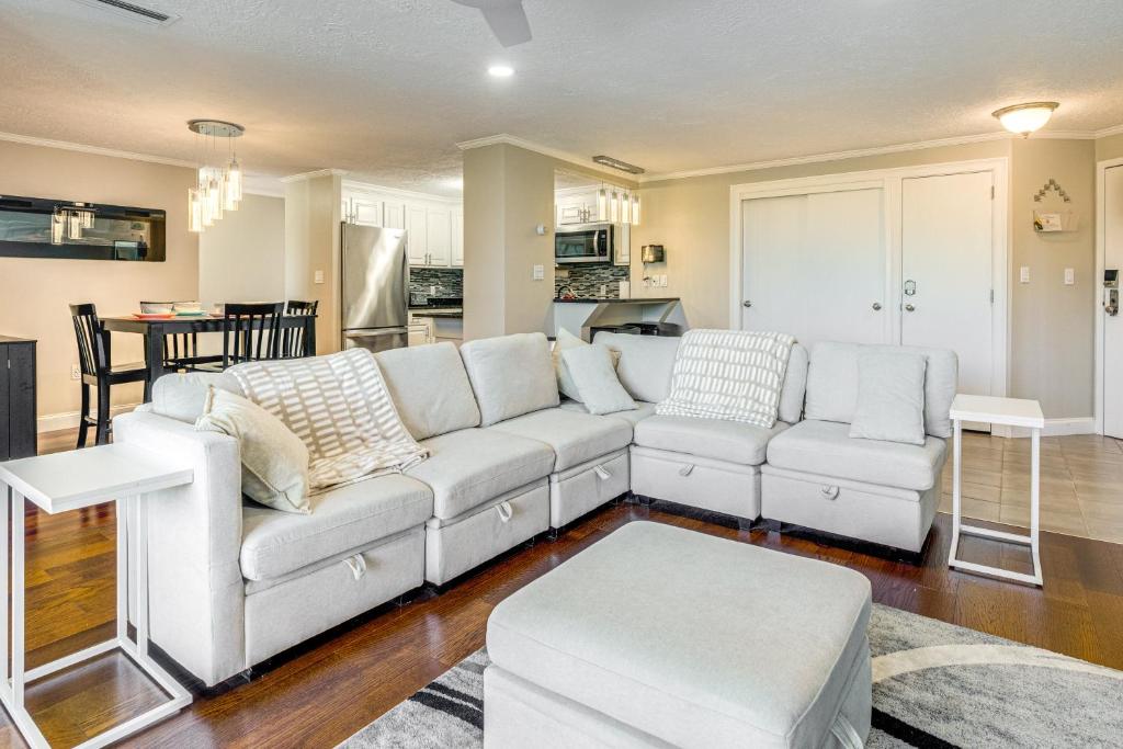 a living room with a white couch and a kitchen at 1 Mi to Millyard District Unit with Furnished Porch in Manchester