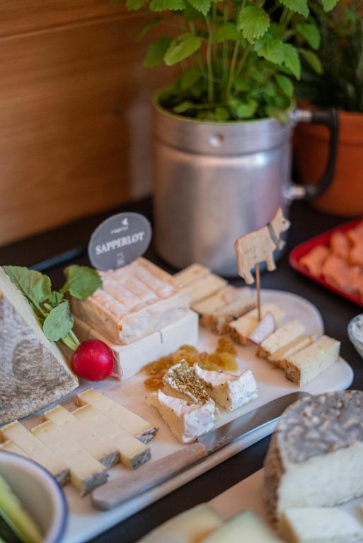 a table topped with cheese and crackers and other foods at La Genzianella Bormio in Bormio