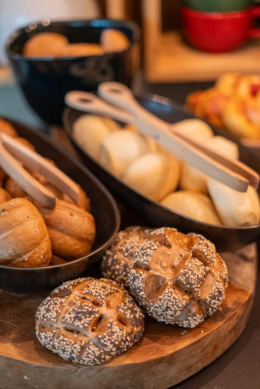 a table with two pans of bagels and other pastries at La Genzianella Bormio in Bormio
