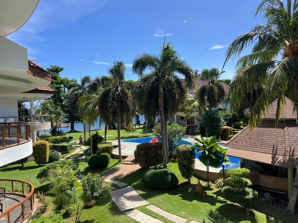 an aerial view of a resort with a swimming pool and palm trees at Luxuary 1 Bedroom Apartment Pool and Sea view in Dauin in Dauin