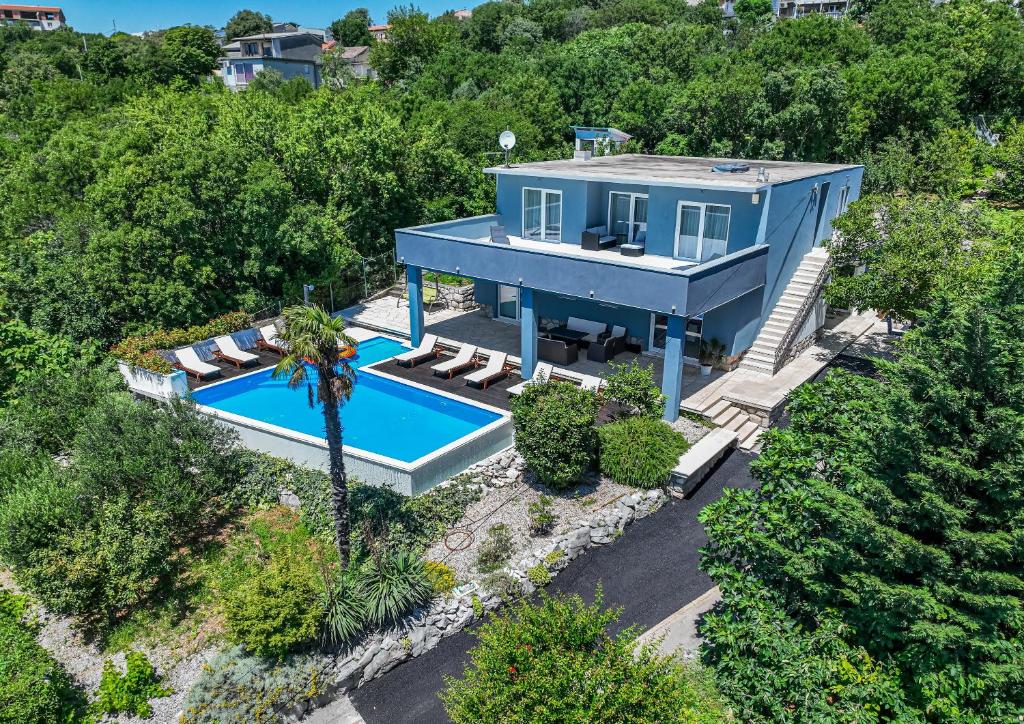 an aerial view of a blue house with a swimming pool at Organic Gardens Villa in Crikvenica