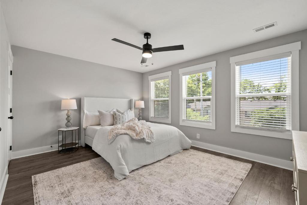 a white bedroom with a bed and two windows at Rivers Edge - 111 Hickory Grove BLVD in Clarksville