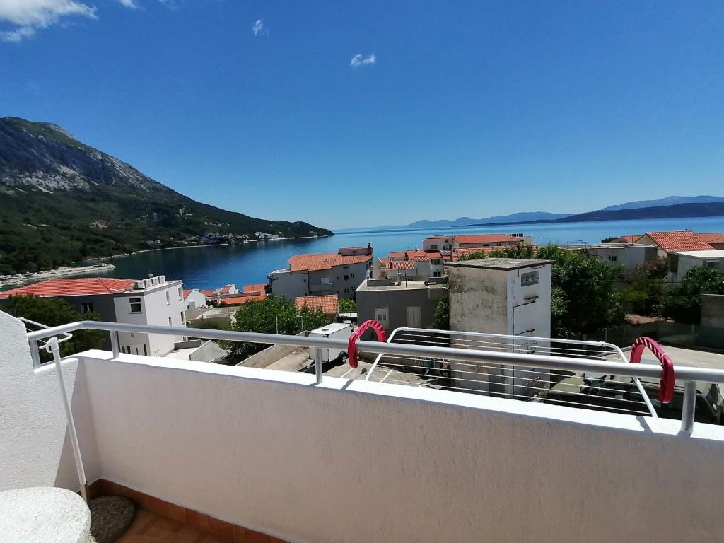 a balcony with a view of a river and buildings at Apartman Dide in Igrane
