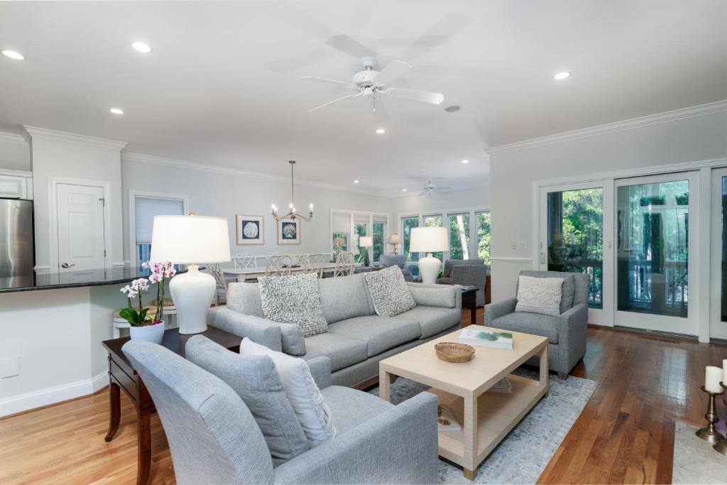 a living room with two couches and a table at 1006 Crooked Oaks in Seabrook Island