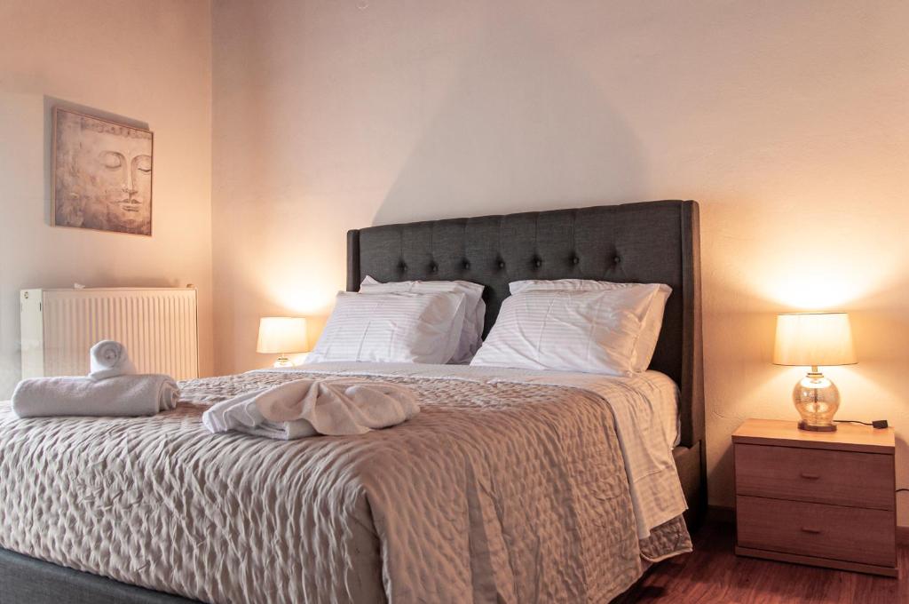 a bedroom with a large bed with white sheets and pillows at Join In Home in Pogoniá