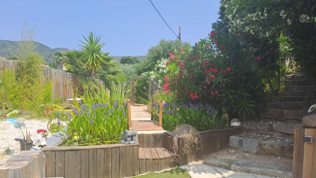 a garden with flowers and a wooden fence at Le Maquis in Alata