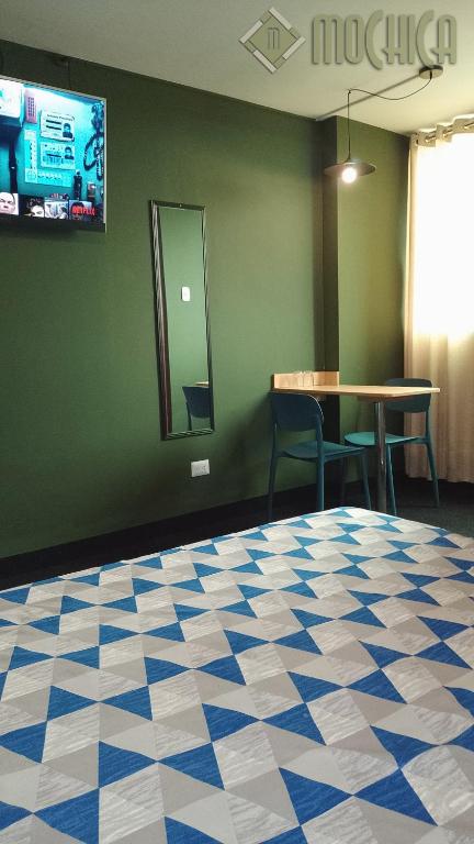 Postel nebo postele na pokoji v ubytování Hostal Residencial Mochica